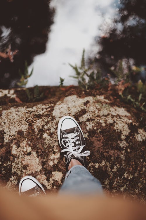 Person Wearing Black and White Sneakers