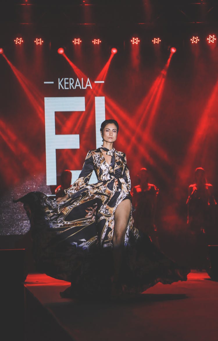 Woman In Brown And Black Dress Walking On The Runway