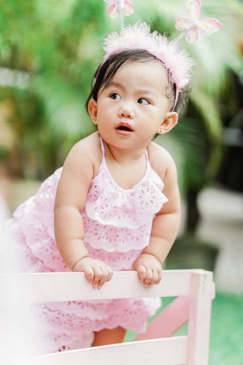 Girl Wearing Pink Dress and Pink Headband