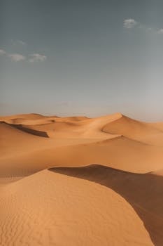 Stunning sand dunes in the Abu Dhabi desert under a clear sky.