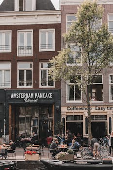 阿姆斯特丹街道充满活力，日间景色迷人，设有咖啡馆和户外座位