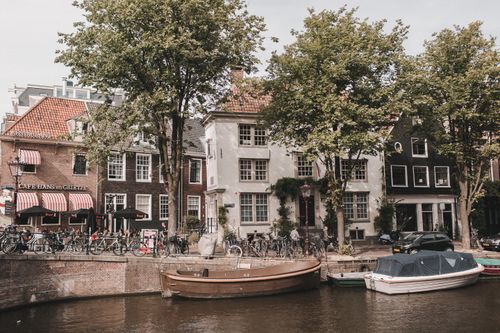 Free Explore the enchanting canals of Amsterdam with iconic bicycles and charming buildings. Stock Photo