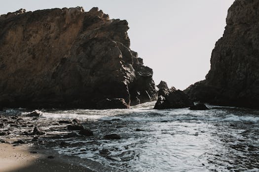 Dramatic rock formations along the Big Sur coast, California, capturing the meeting of sea and shore.