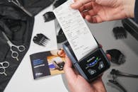 Unrecognizable person taking check from cash register