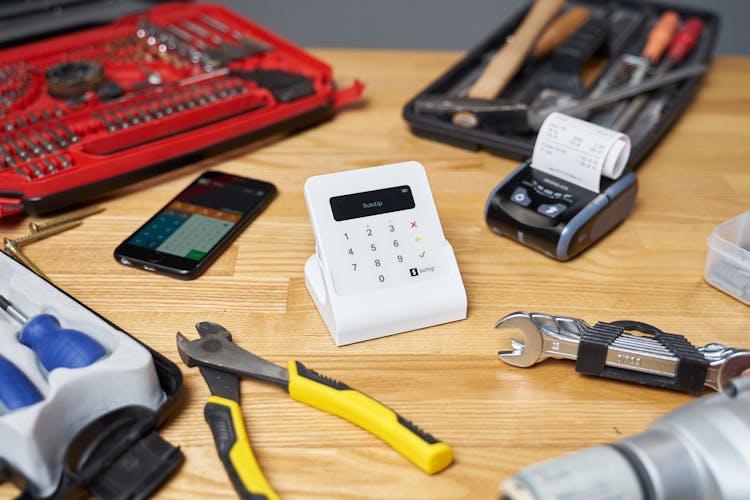 Cash Register And Cellphone Among Tools And Tacks