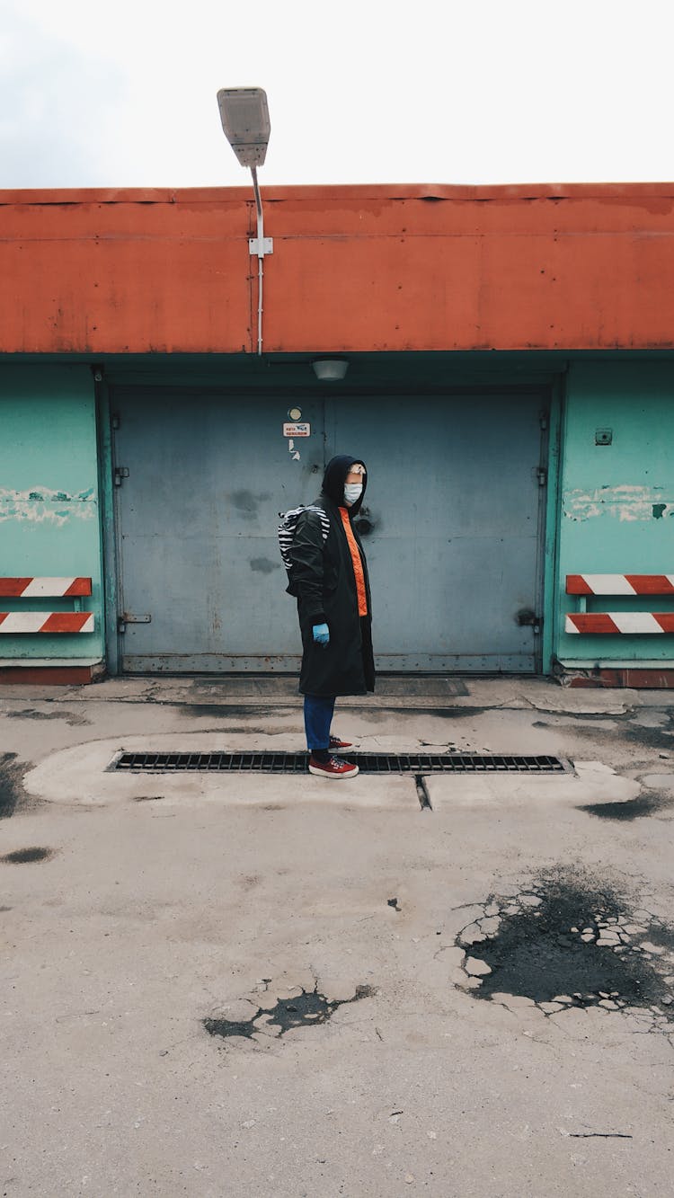 Person With A Face Mask And Latex Gloves Standing Outside