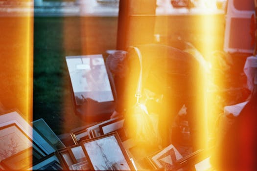 Art frames displayed at a vintage market with cinematic light leaks creating a dreamy effect.