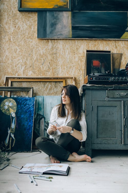 Woman in White Shirt Sitting on Floor