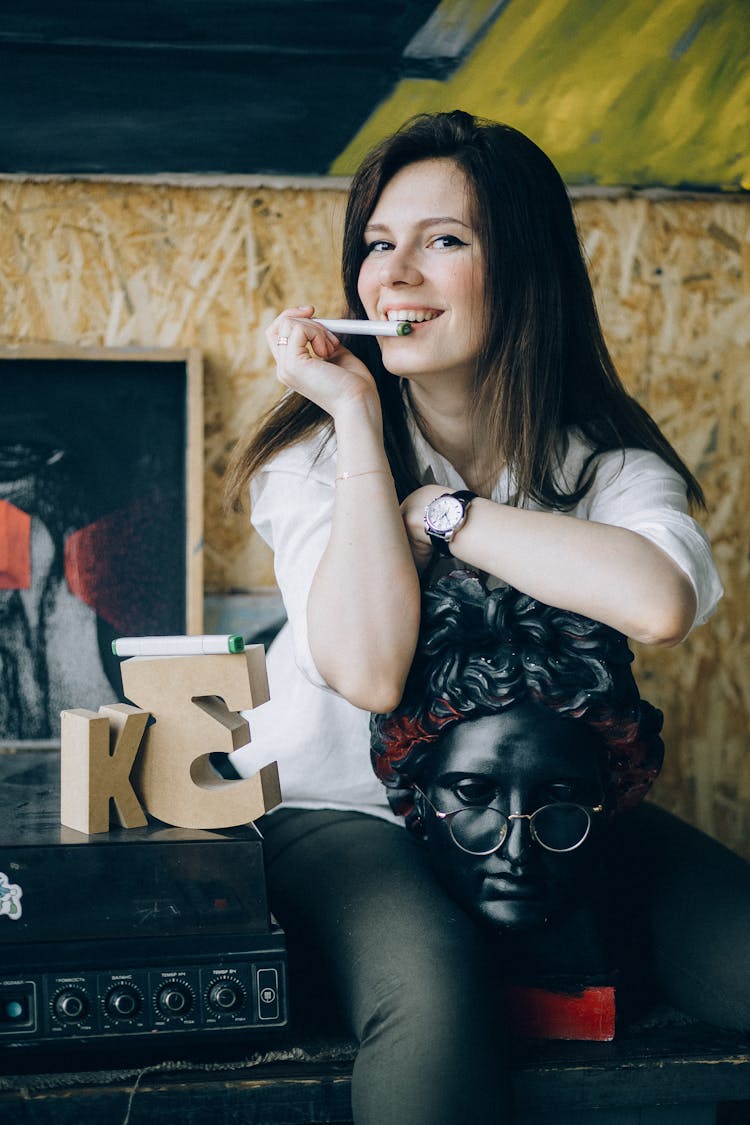 Woman In White Shirt While Leaning On Gypsum Head