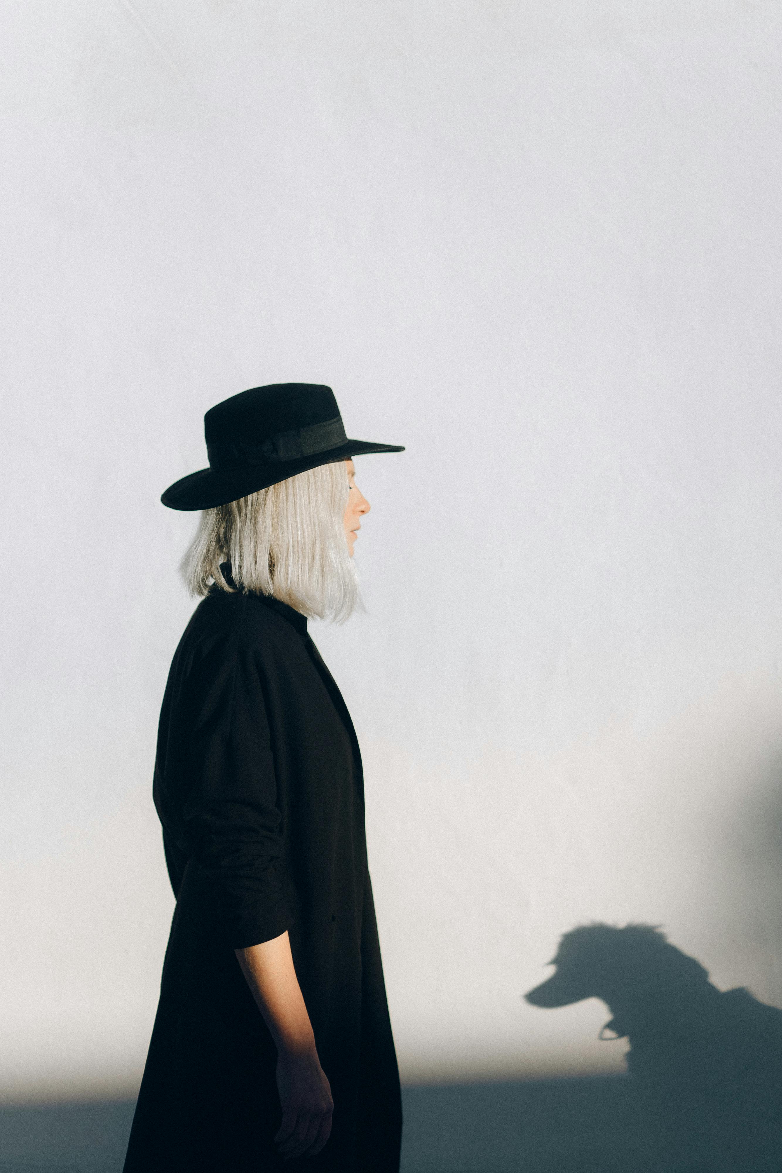 Woman in Black Long Sleeve Shirt and Black Hat · Free Stock Photo