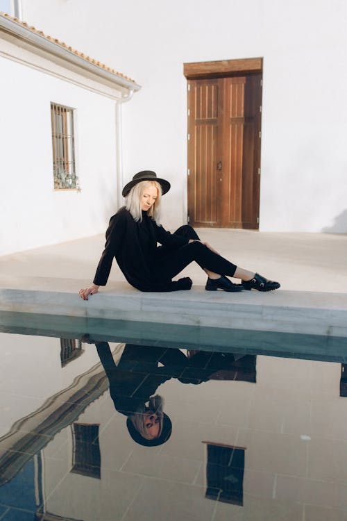 Photo of Woman Sitting by the Pool