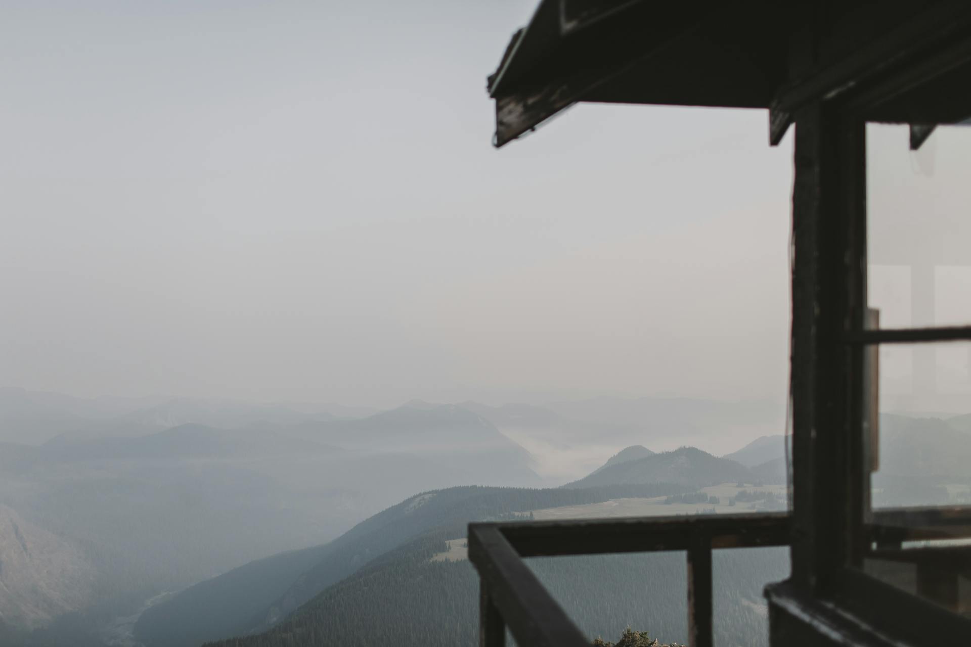 Peaceful mountain view from a cabin in Washington State, showcasing serene, misty hills.