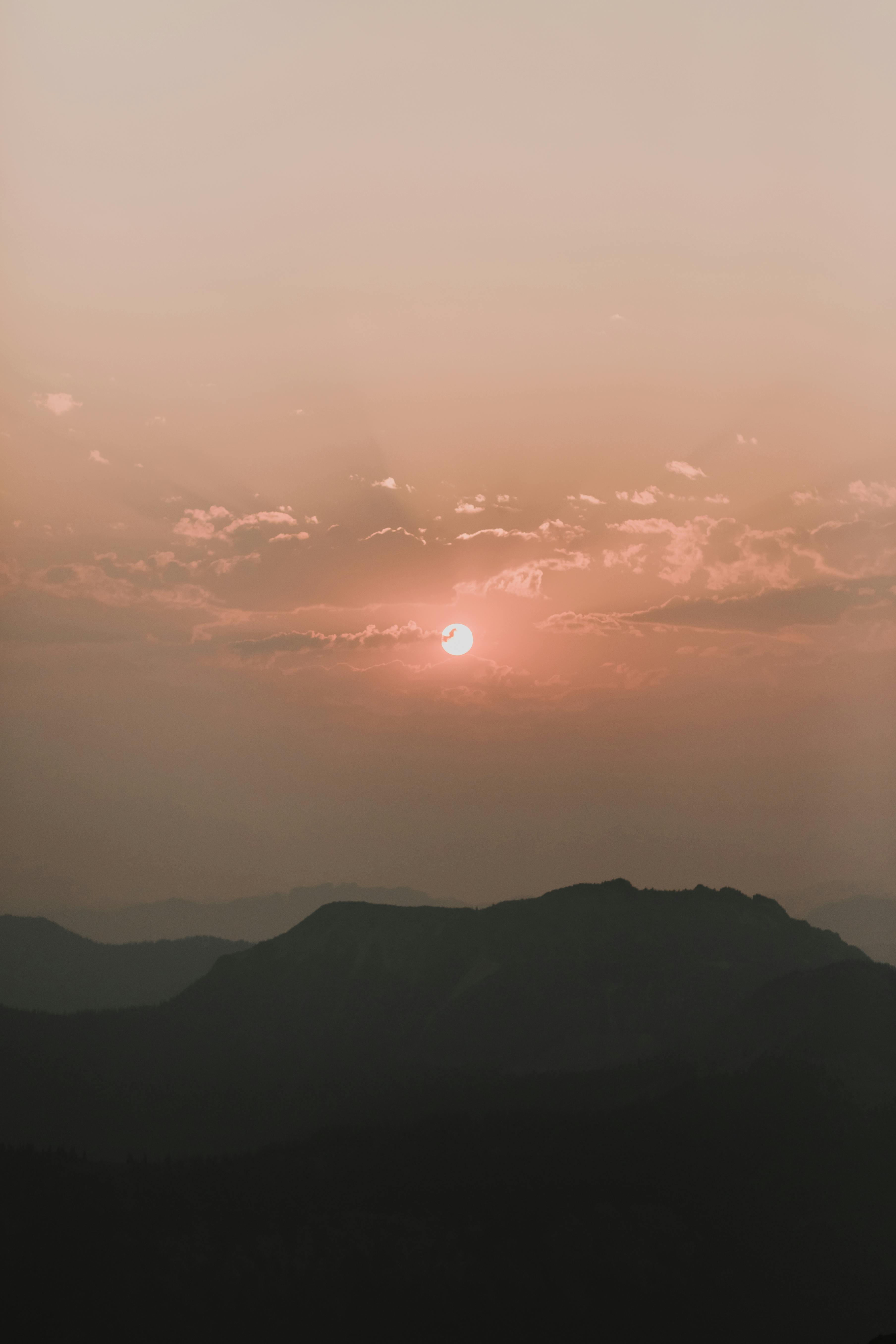 sunrise among clouds over hill