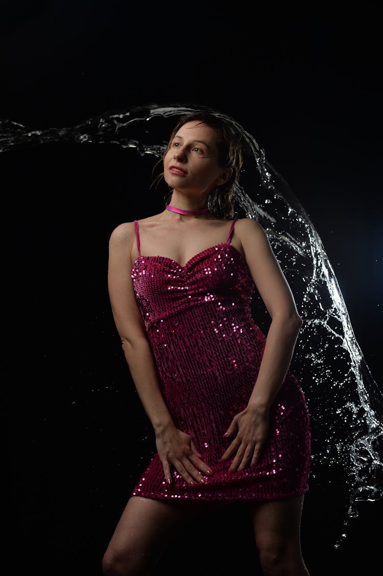 Slim Woman In Dress Under Water Splash