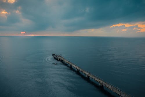 Colorful sky above long pier
