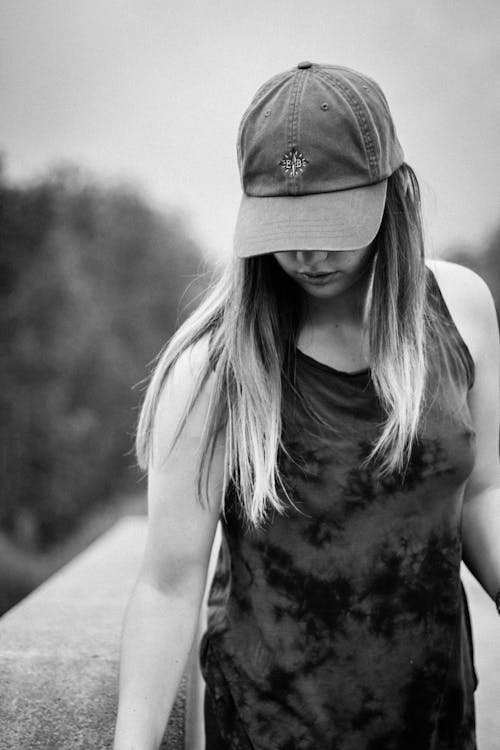 Woman Wearing Cap While Looking Down