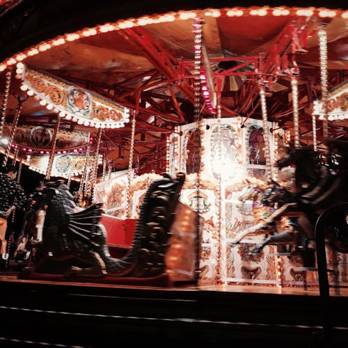 People Riding on Carousel during Night Time