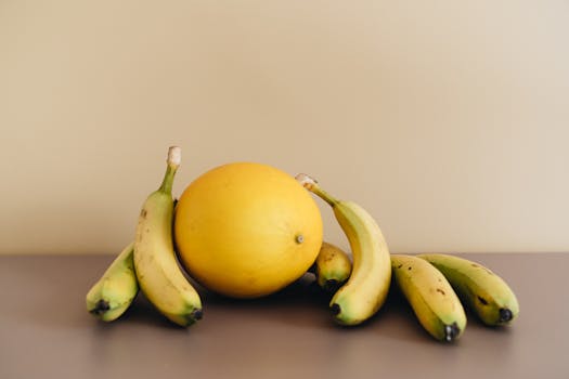 A minimalistic still life of bananas and a melon, perfect for organic and simple themes.