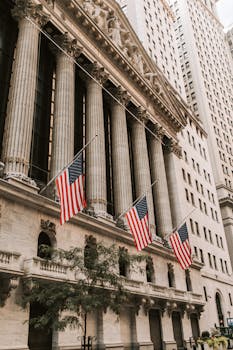 Iconic New York Stock Exchange with American flags on Wall Street, USA.