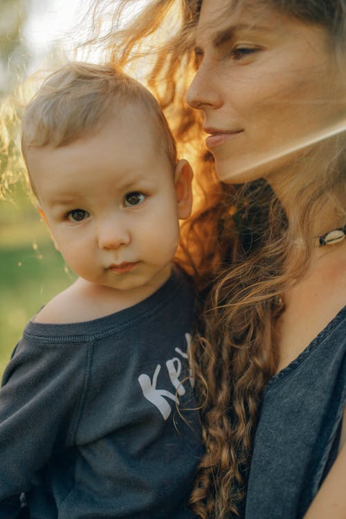 A Close-Up Shot of a Mother Carrying Her Child