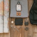 Gray Shirt and Leather Wallet on Wooden Surface