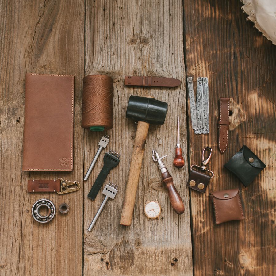 Leather crafting tools arranged on a rustic wooden bench — photo by Vlada Karpovich on Pexels