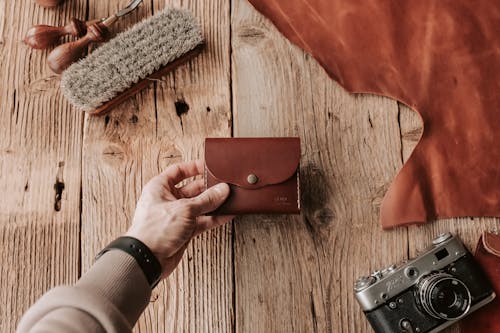 Man Holding a Handmade Brown Leather Wallet 