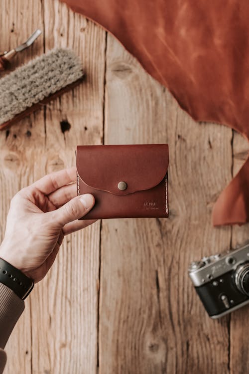Man Holding a Handmade Brown Leather Wallet