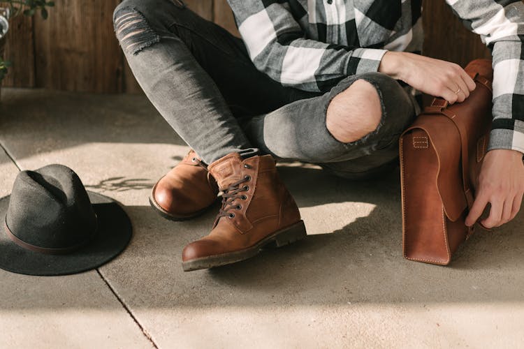 Person Holding A Brown Leather Briefcase