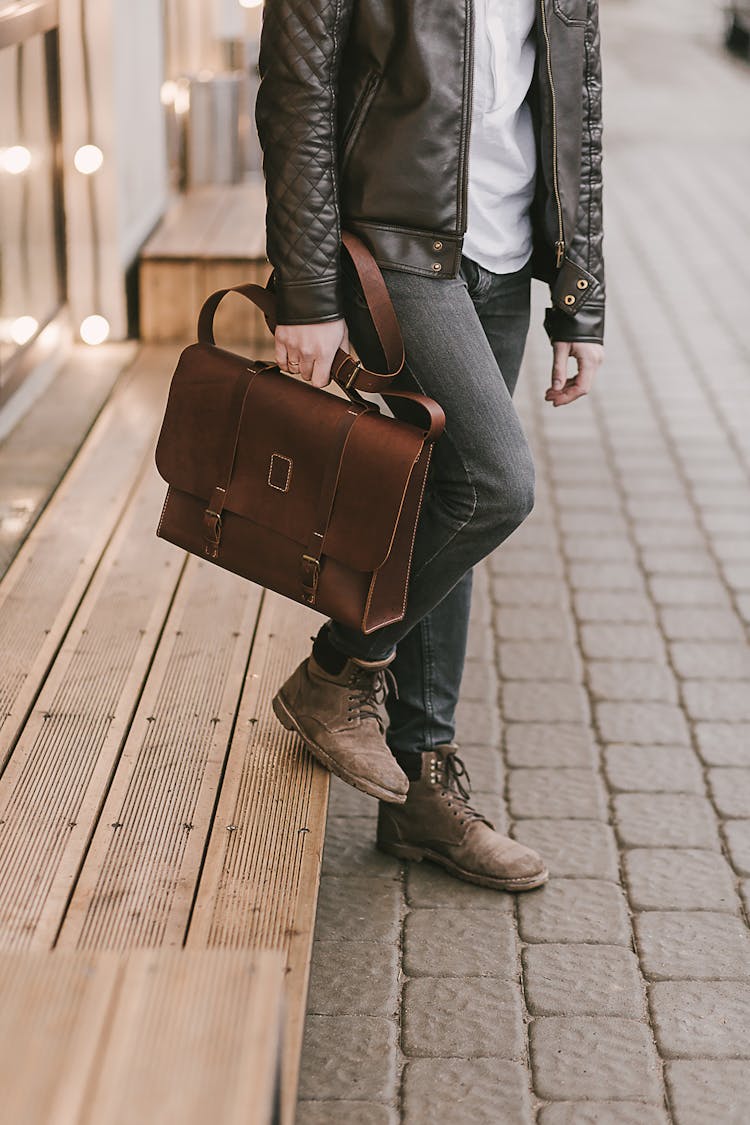 Person Holding A Brown Leather Briefcase