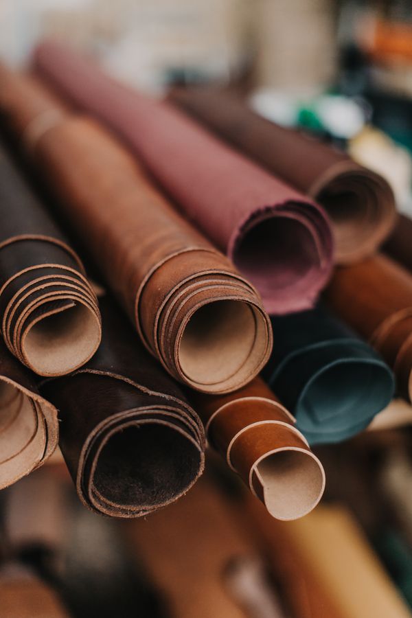 Rolls of dyed hide in a workshop, photo by Vlada Karpovich on Pexels