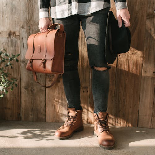 Person in Blue Denim Jeans and Brown Leather Shoes