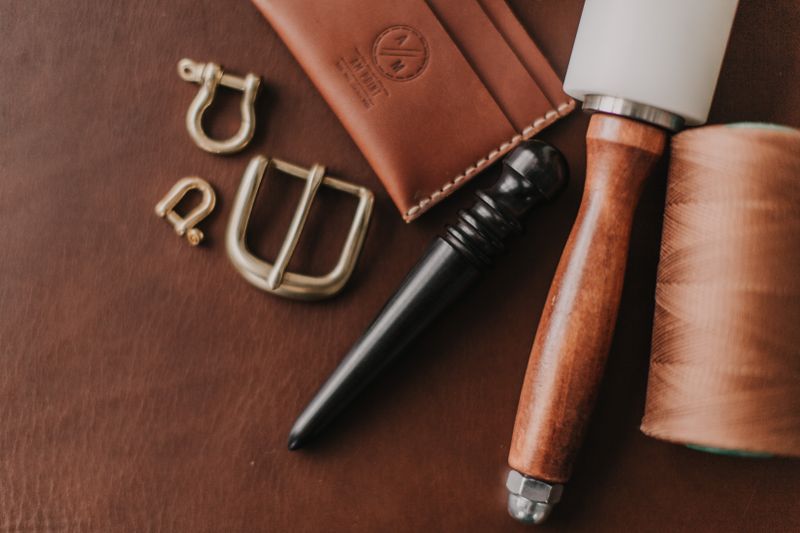 Overhead view of a leather crafting workstation with tools