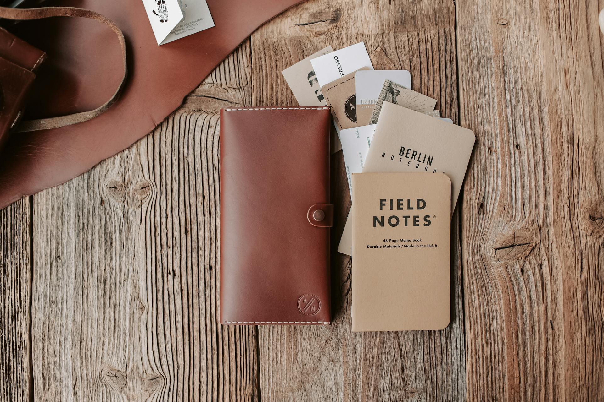 Brown Leather Wallet and Cards on Wooden Surface