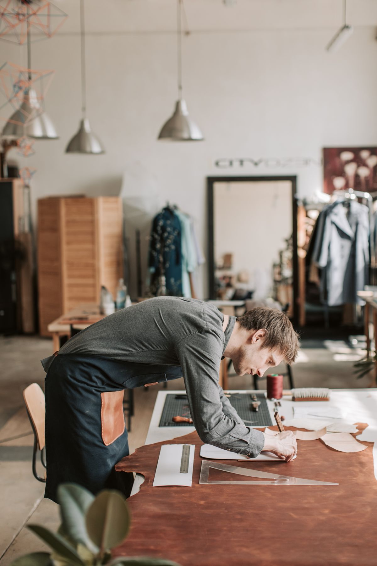 Leather craftsperson working at a table