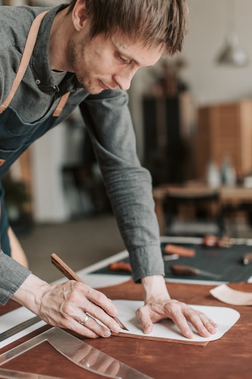 Man Cutting Leather using a Cutter