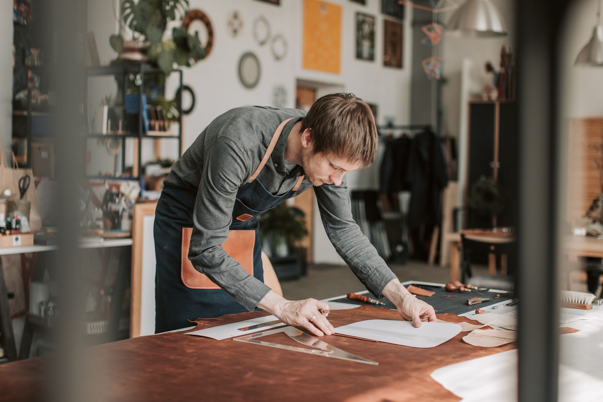 Man Bending over Table and Working