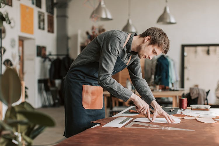 
A Man Cutting Leather