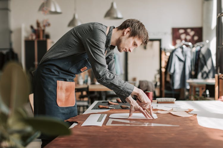 A Man Cutting Leather