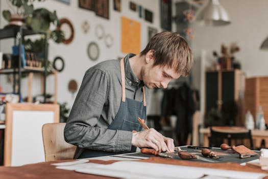 Skilled artisan meticulously crafting leatherwork at a workshop table.