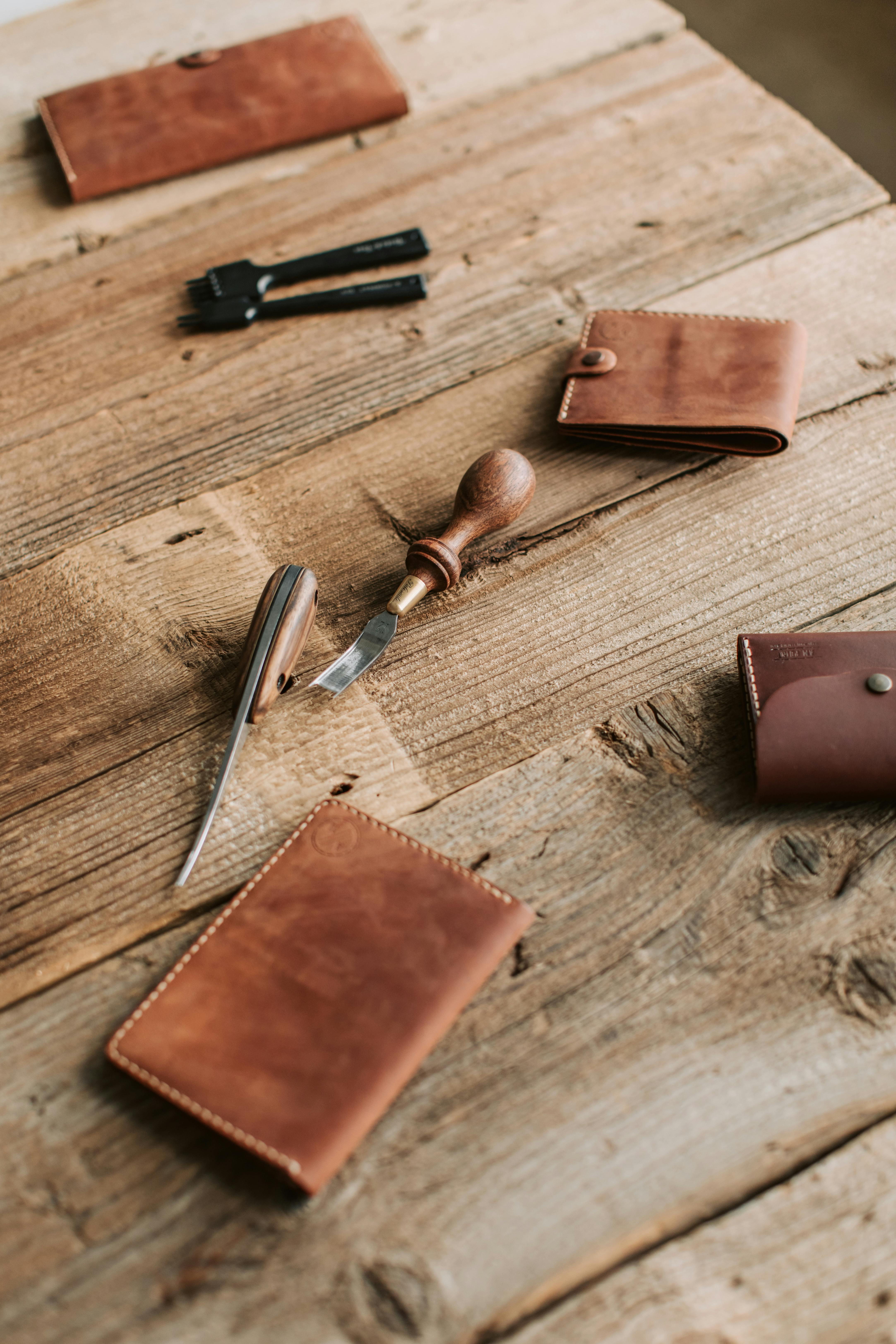 a close up shot of leather products and leather craft tools