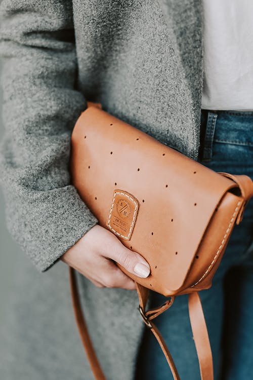 Free 

A Person Holding a Leather Bag Stock Photo