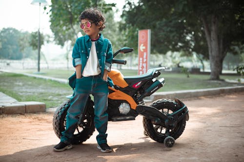 A Boy Leaning on a Motorcycle