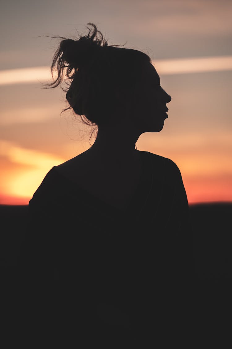 Unrecognizable Woman At Sunset In Summer