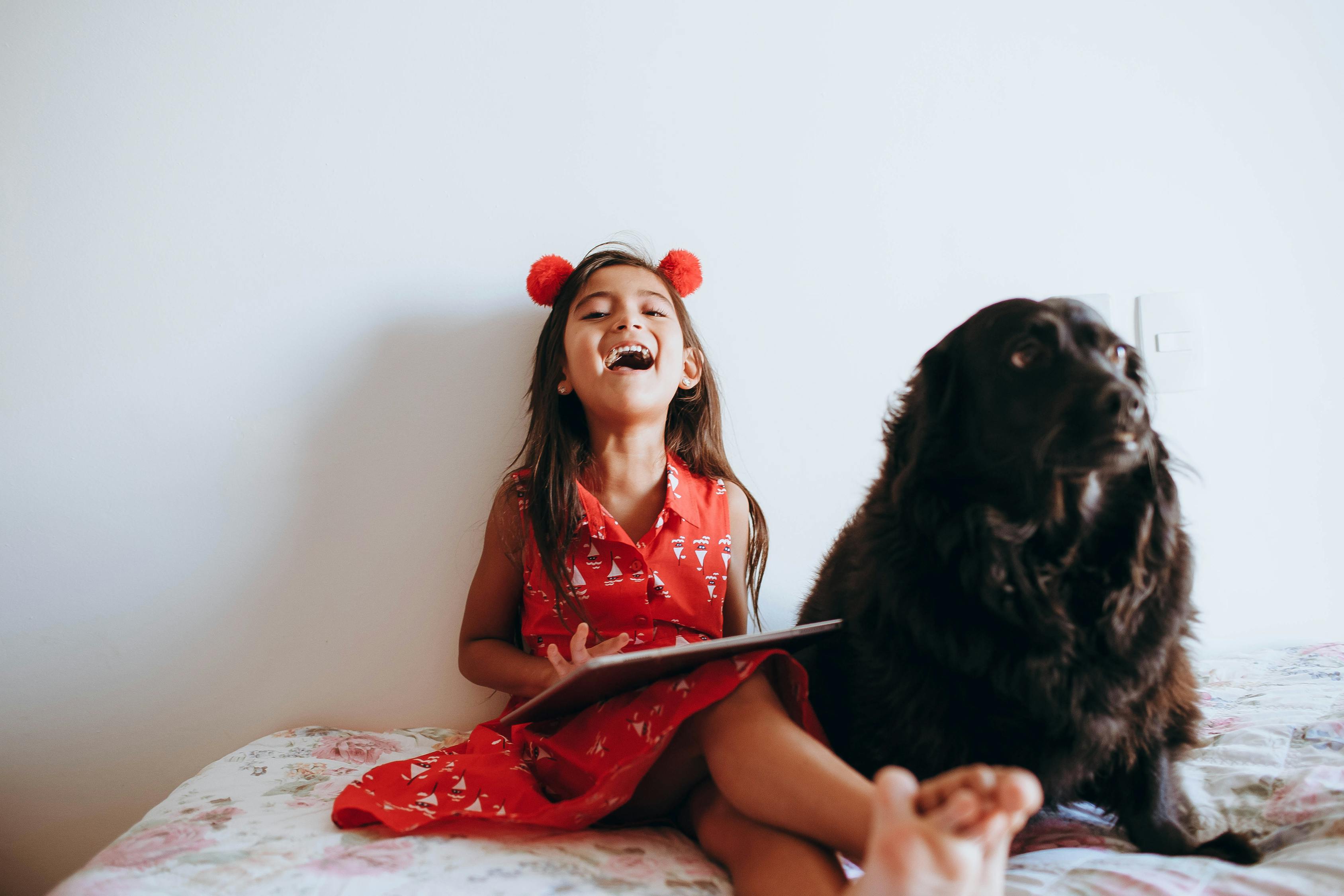 Child Sitting And Read With Dog`s Support