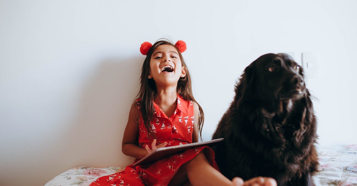 Happy Girl Sitting Beside Black Dog