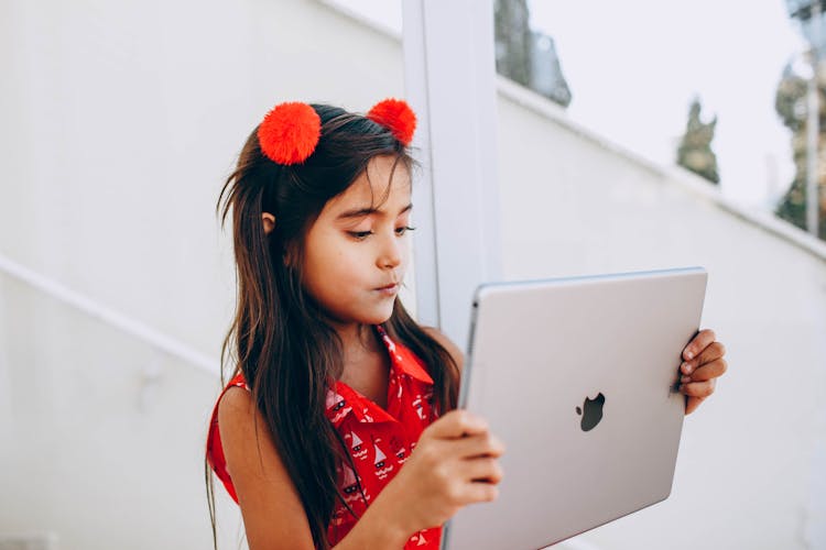 Girl In Red Dress Holding Silver Ipad Pro