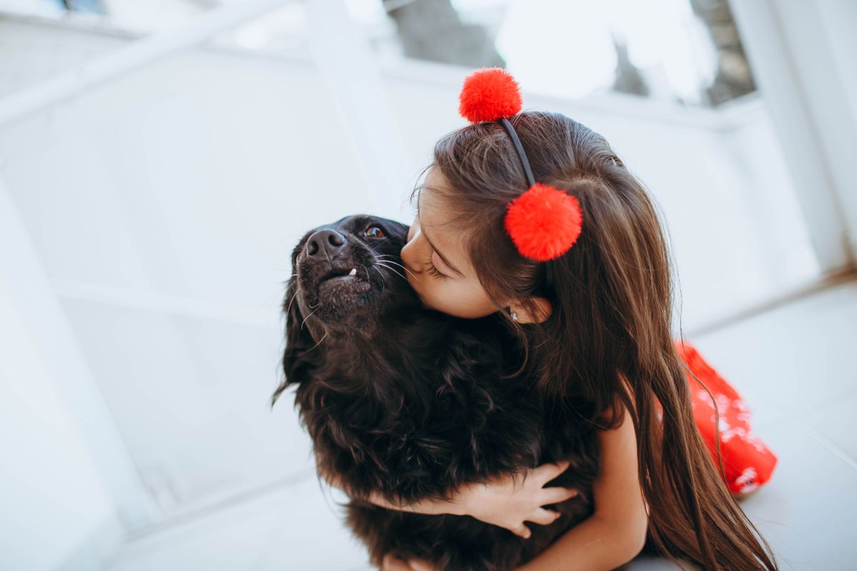 A young girl hugging her dog close, finding comfort together