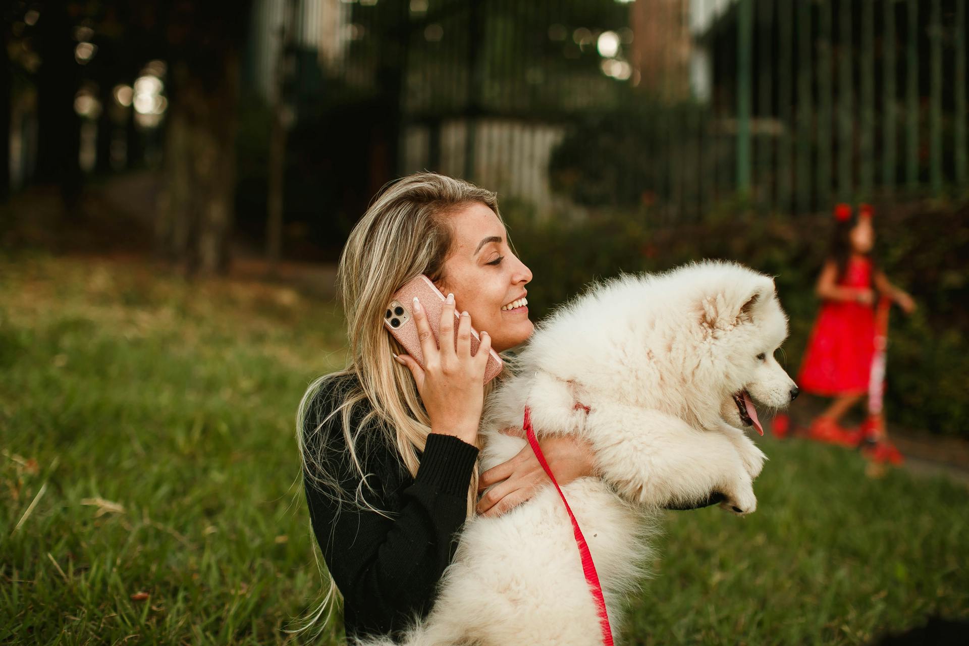 Woman Holding a White Dog