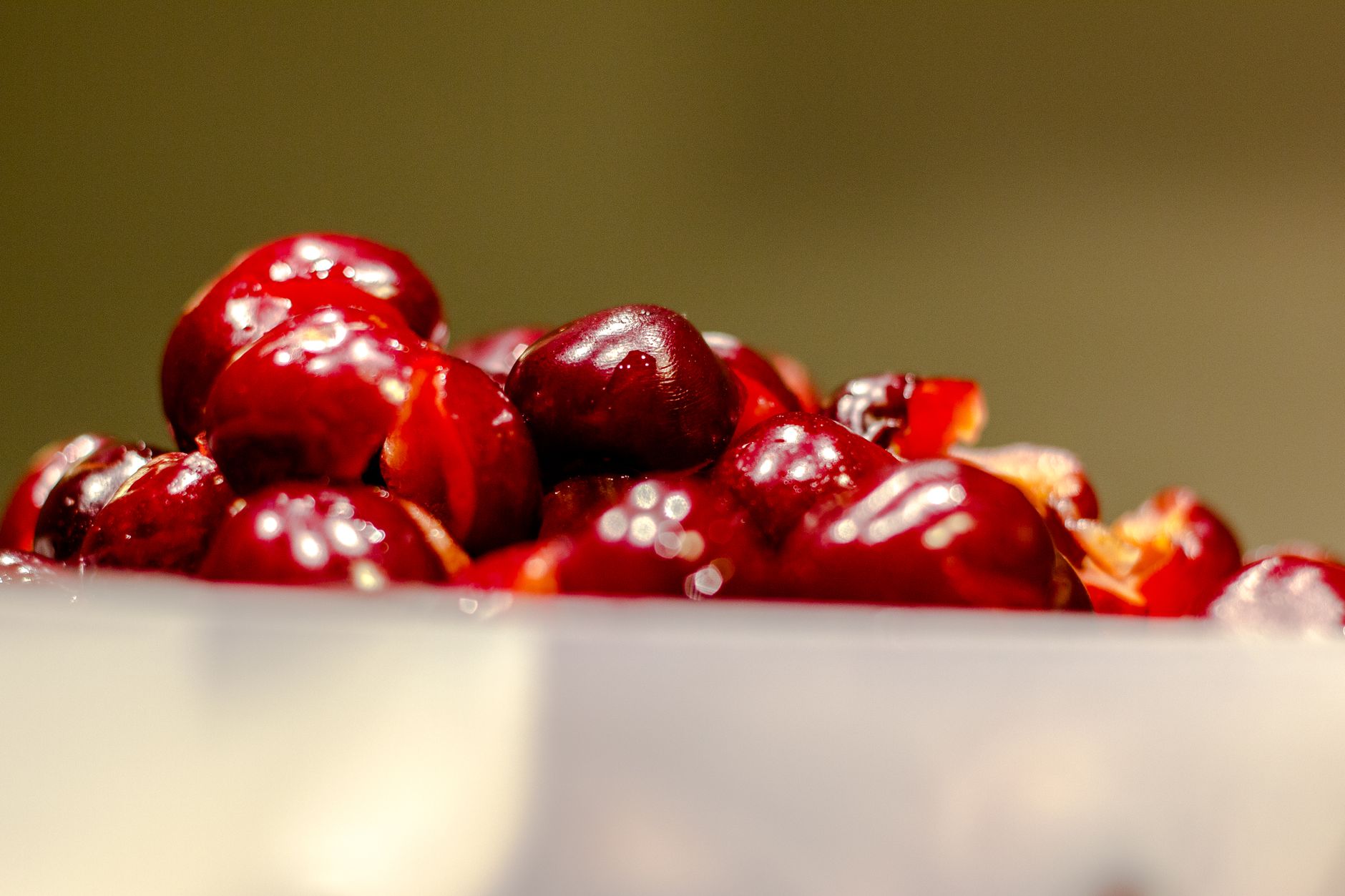 Fresh cherries with pits on a rustic wooden table